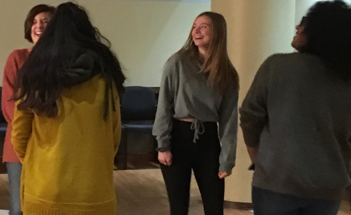 Four women actors smile while doing an activity